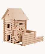 A water mill built using the Walachia Vario Mill Wooden Building Set 122 Pieces. This modular wooden building block system is perfect for those who enjoy a challenge. The sets are available in various sizes at Babipur.  