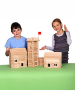 Children standing by build created using the wooden pieces from the Walachia Vario Massive Box Wooden Building Set 418 Pieces.