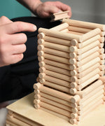 A close up of a  structure being built using Walachia Vario logs. This modular wooden building block system is perfect for those who enjoy a challenge. The sets are available in various sizes at Babipur.  