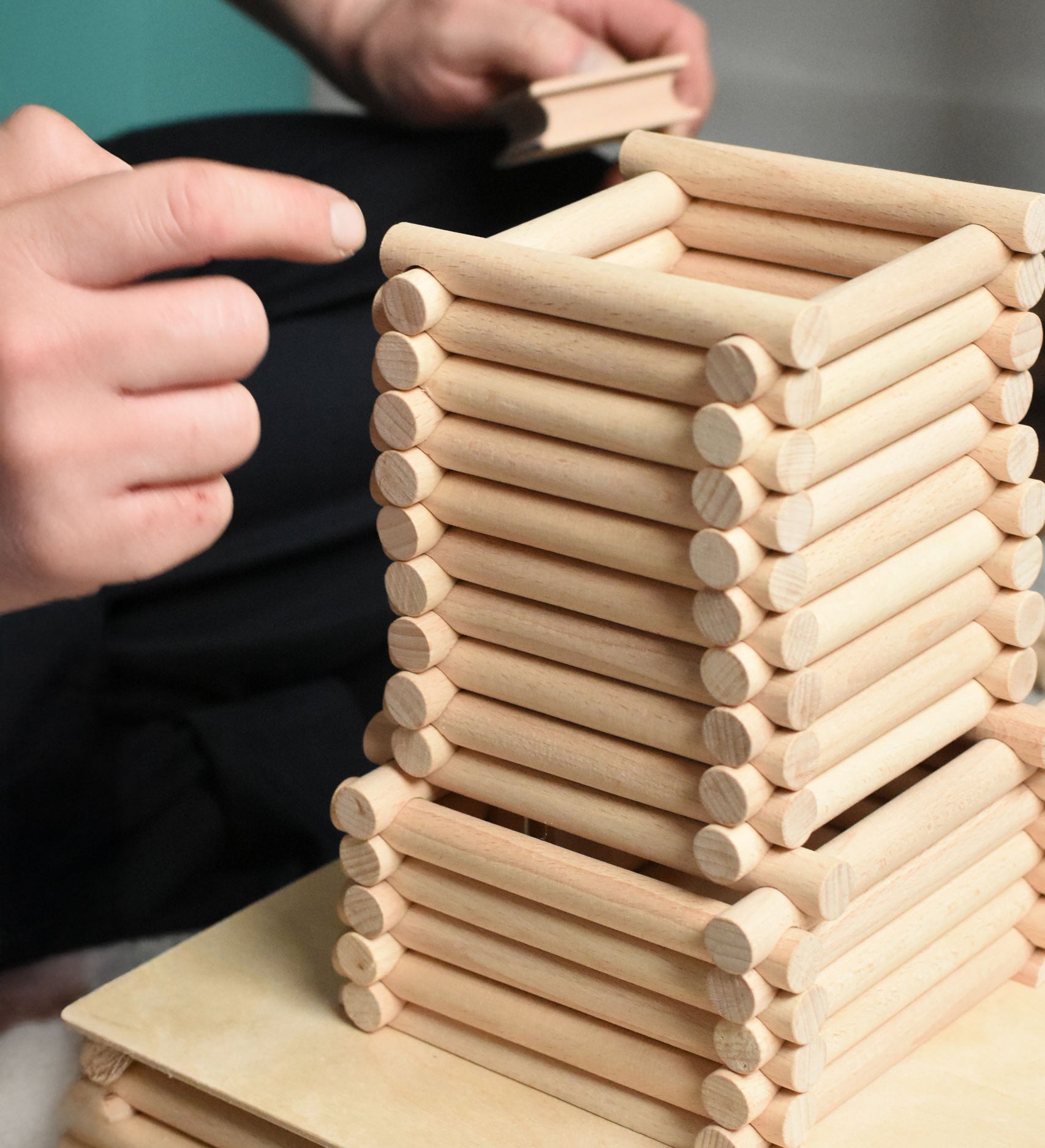 A close up of a  structure being built using Walachia Vario logs. This modular wooden building block system is perfect for those who enjoy a challenge. The sets are available in various sizes at Babipur.  