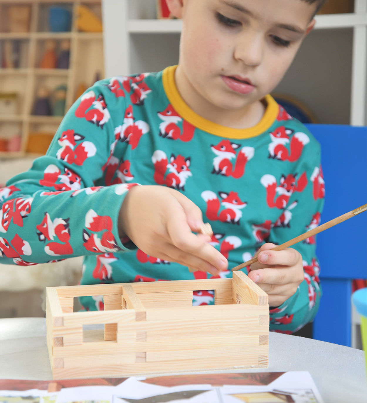 A child patiently and carefully building a WALACHIA hobby kit