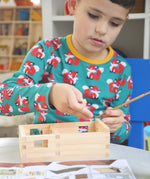 A child patiently and carefully building a WALACHIA hobby kit