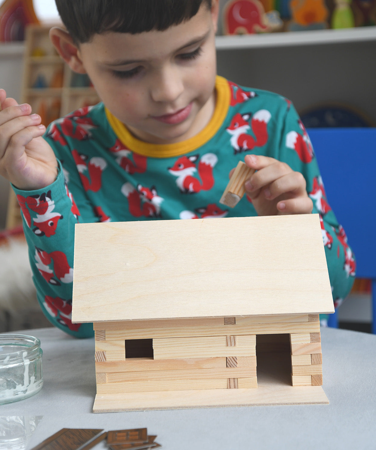 A child patiently and carefully building a WALACHIA hobby kit