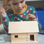 A child patiently and carefully building a WALACHIA hobby kit