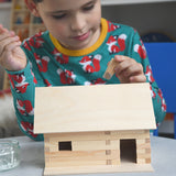 A child patiently and carefully building a WALACHIA hobby kit