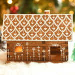 A beautifully festive decorated WALACHIA log cabin house. There are little fairy lights in the house creating a lovely warm glow inside