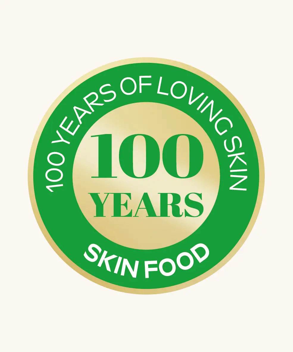 A green and gold  roundel showing 100 years of loving skin food from Weleda