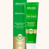 A green and gold limited edition Weleda skin food 100ml tube and box 