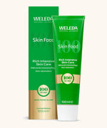 A green and gold limited edition Weleda skin food 100ml tube and box 