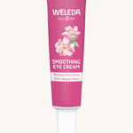 Weleda wild rose  and white tea soothing eye cream. Showing a pink tube with branding on the front and features a white cap.