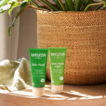 A tube of Weleda Skin Food pictured next to the Skin Food Light