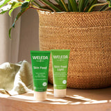 A tube of Weleda Skin Food pictured next to the Skin Food Light