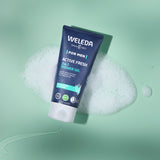 Weleda Men’s Active Fresh 3 in 1 Shower Gel tube resting on green foam with bubbles.