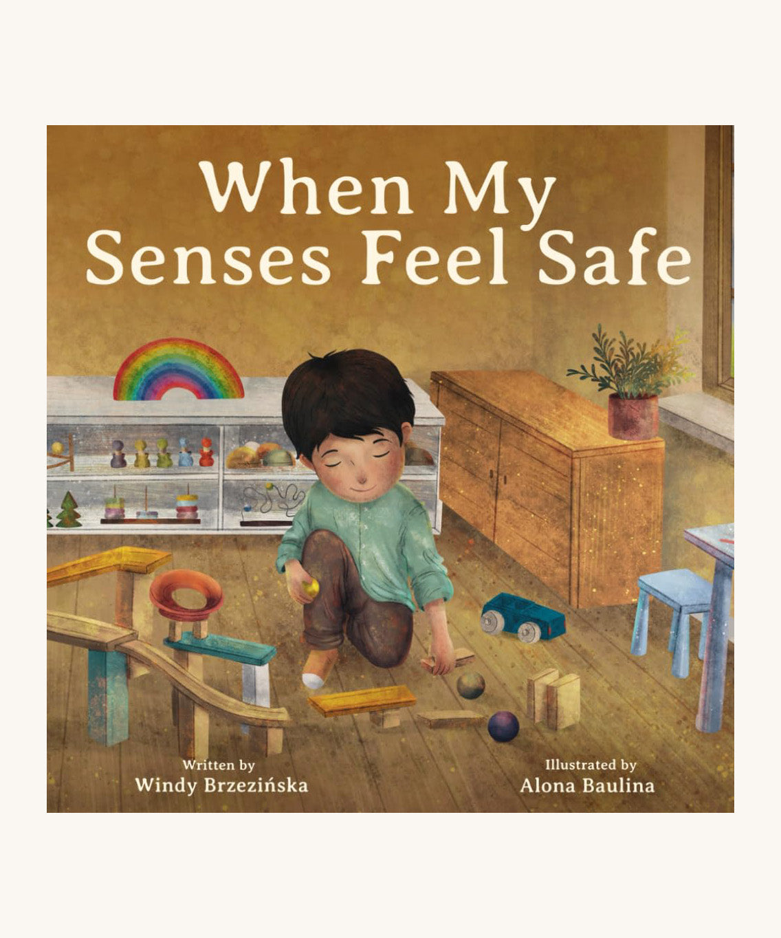The front cover of When My Senses Feel Safe By Windy Brzezinska. A beautifully illustrated children's story book, with the cover showing a child in a playing with ball run pieces in a playroom 