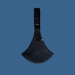 The black corduroy Wildride toddler carrier sling, on a blue background. 