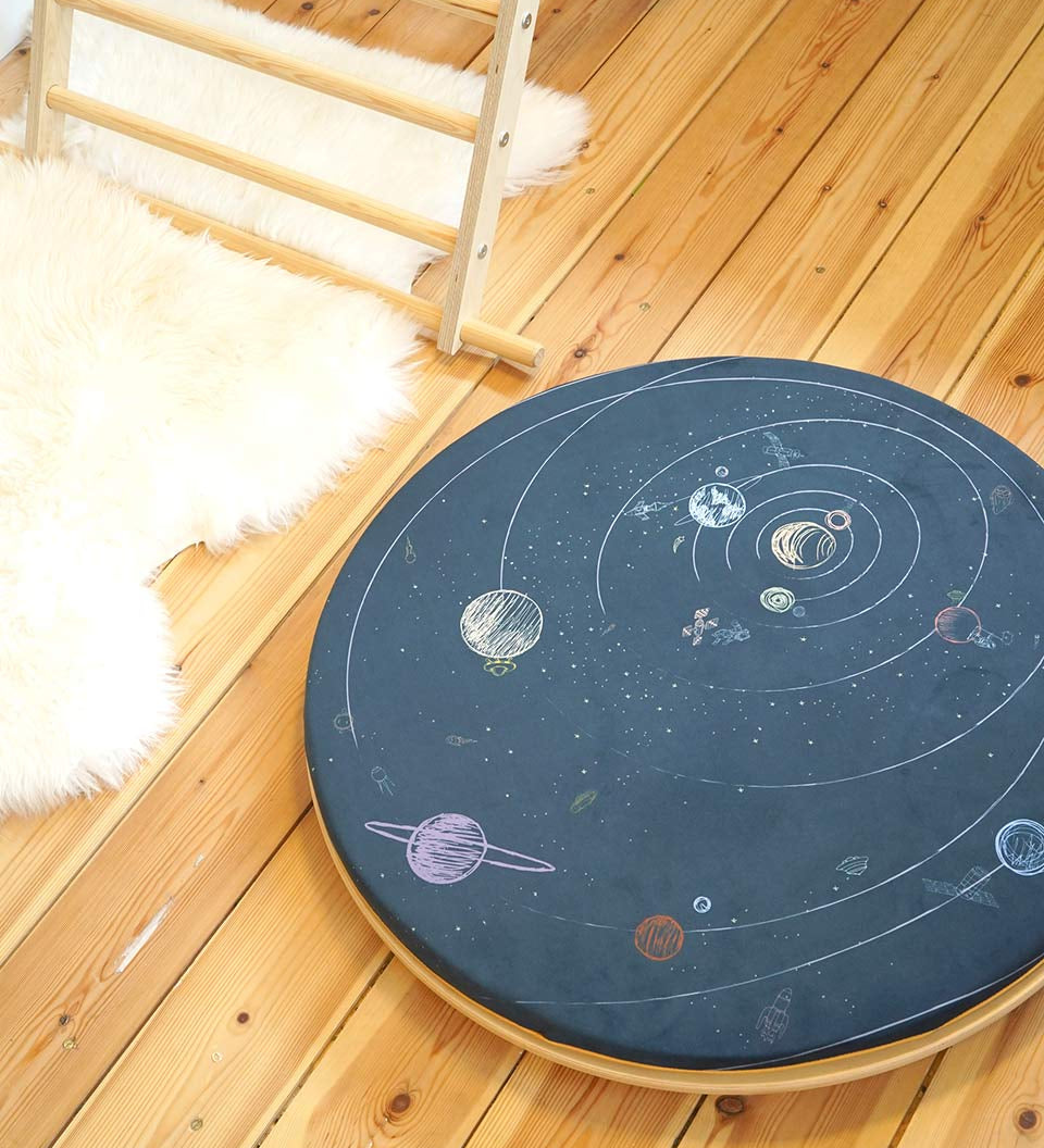 Close up of the Wobbel 360 eco-friendly deck and pillow cushion accessories on a Wobbel balance board on a wooden floor