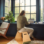 Man sat working at a windowsill