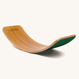 Wobbel Original bamboo balance board with foliage green wool felt backing shown in curved profile