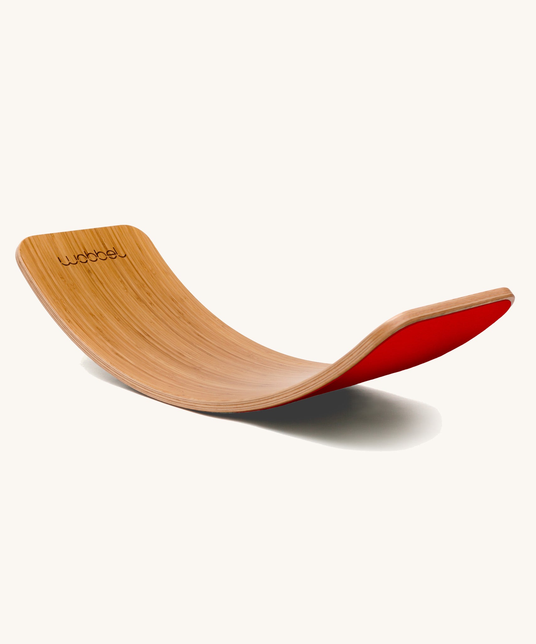 Wobbel Original bamboo balance board with red wool felt backing on a plain background.