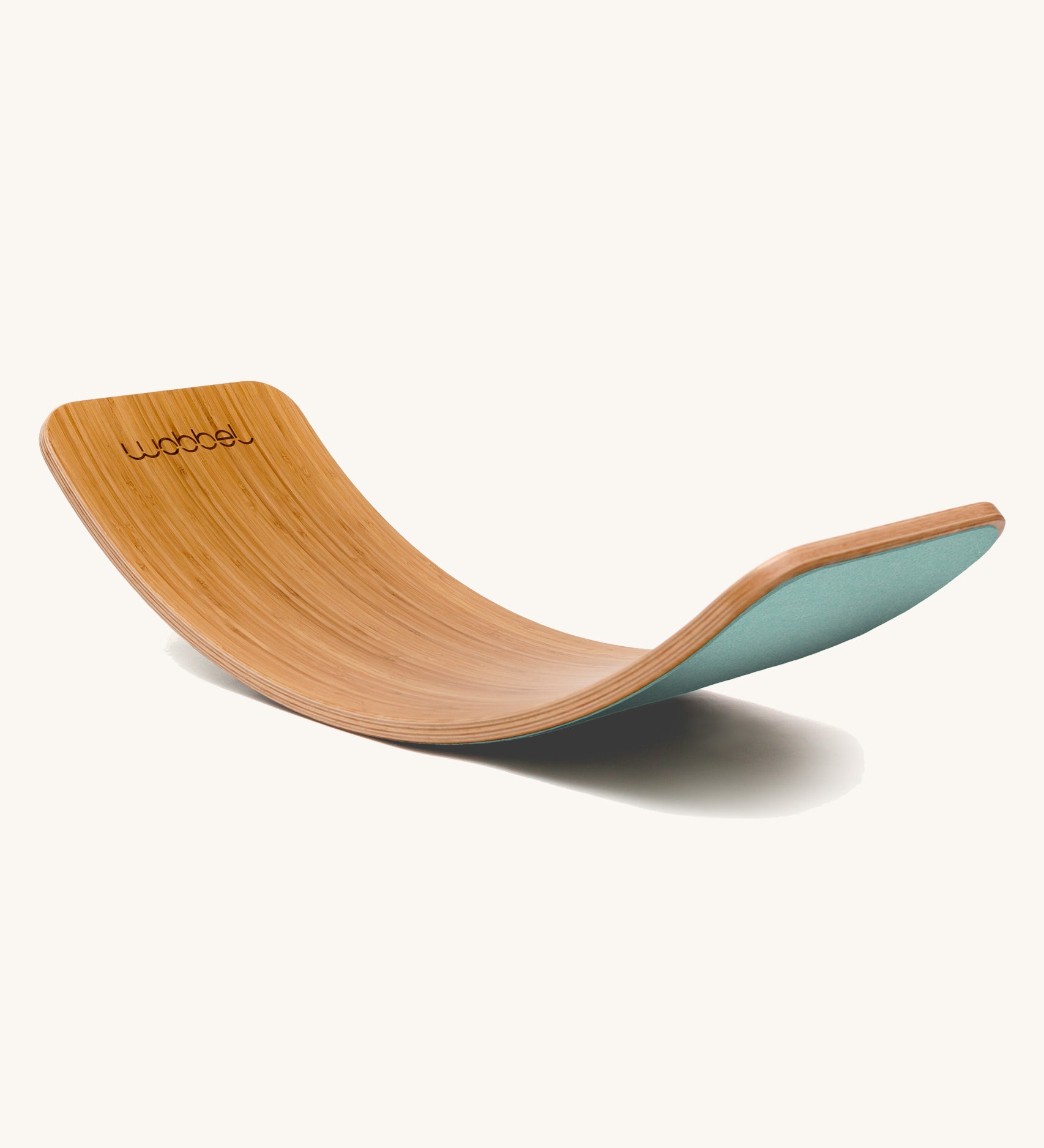 Wobbel Original bamboo balance board with sky blue wool felt backing shown in a curved side profile.