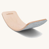 Wobbel Original beech balance board with baby mouse recycled felt backing on a plain background.
