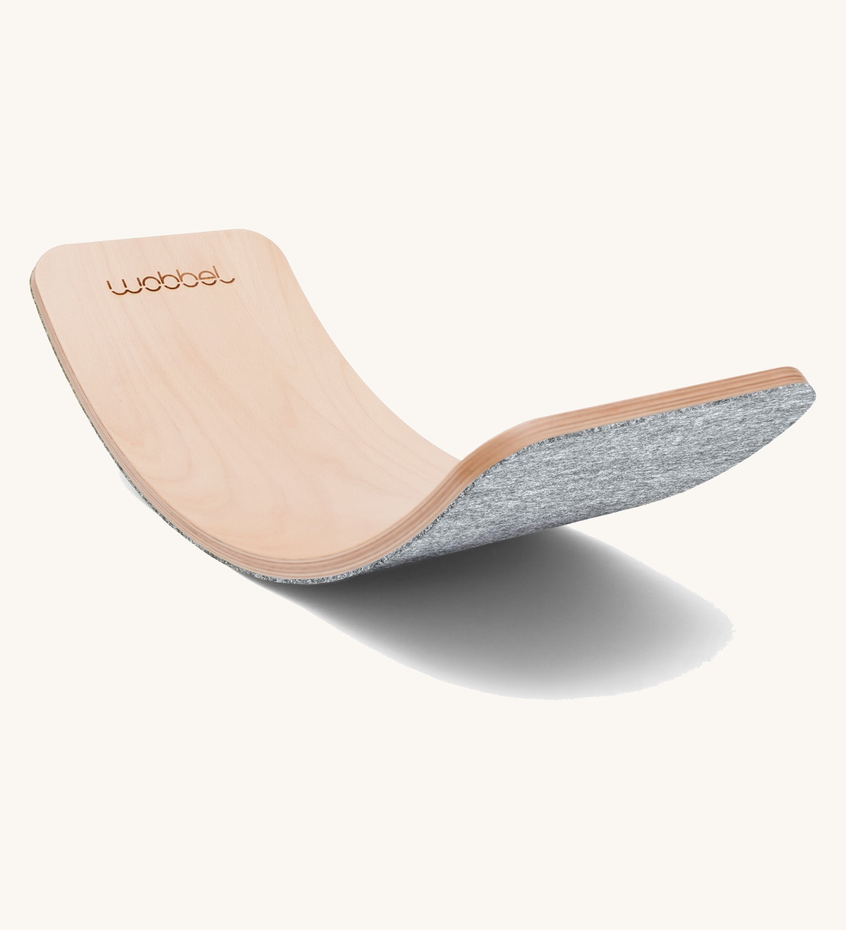 Wobbel Original beech balance board with baby mouse recycled felt backing on a plain background.