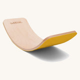 Wobbel Original beech balance board with mustard recycled felt base displayed in curved profile