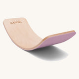 Wobbel Original beech balance board with wild rose recycled felt backing shown in a soft curve.