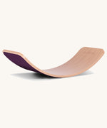 Wobbel Original beech balance board with aubergine wool felt backing on a plain background