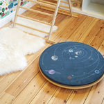 Wobbel 360 eco-friendly deck and pillow cushion accessories on a Wobbel balance board on a wooden floor