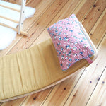 Close up of the Wobbel eco-friendly deck and pillow cushion accessories on a Wobbel XL balance board on a wooden floor