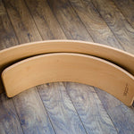 Wobbel Starter Board next to a standard Wobbel Board on a wooden floor
