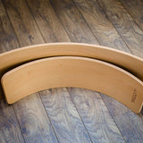 Wobbel Starter Board next to a standard Wobbel Board on a wooden floor