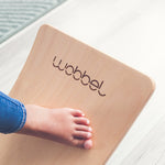 Close up of childs foot on a Wobbel Starter Beech Wood wobble board