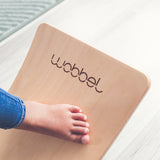 Close up of childs foot on a Wobbel Starter Beech Wood wobble board