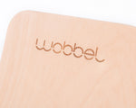 Close up of Wobbel Beech Wood balance board on a white background