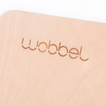 Close up of Wobbel Beech Wood balance board on a white background