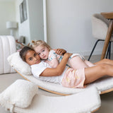 Two children lying on an extra large wobbel board