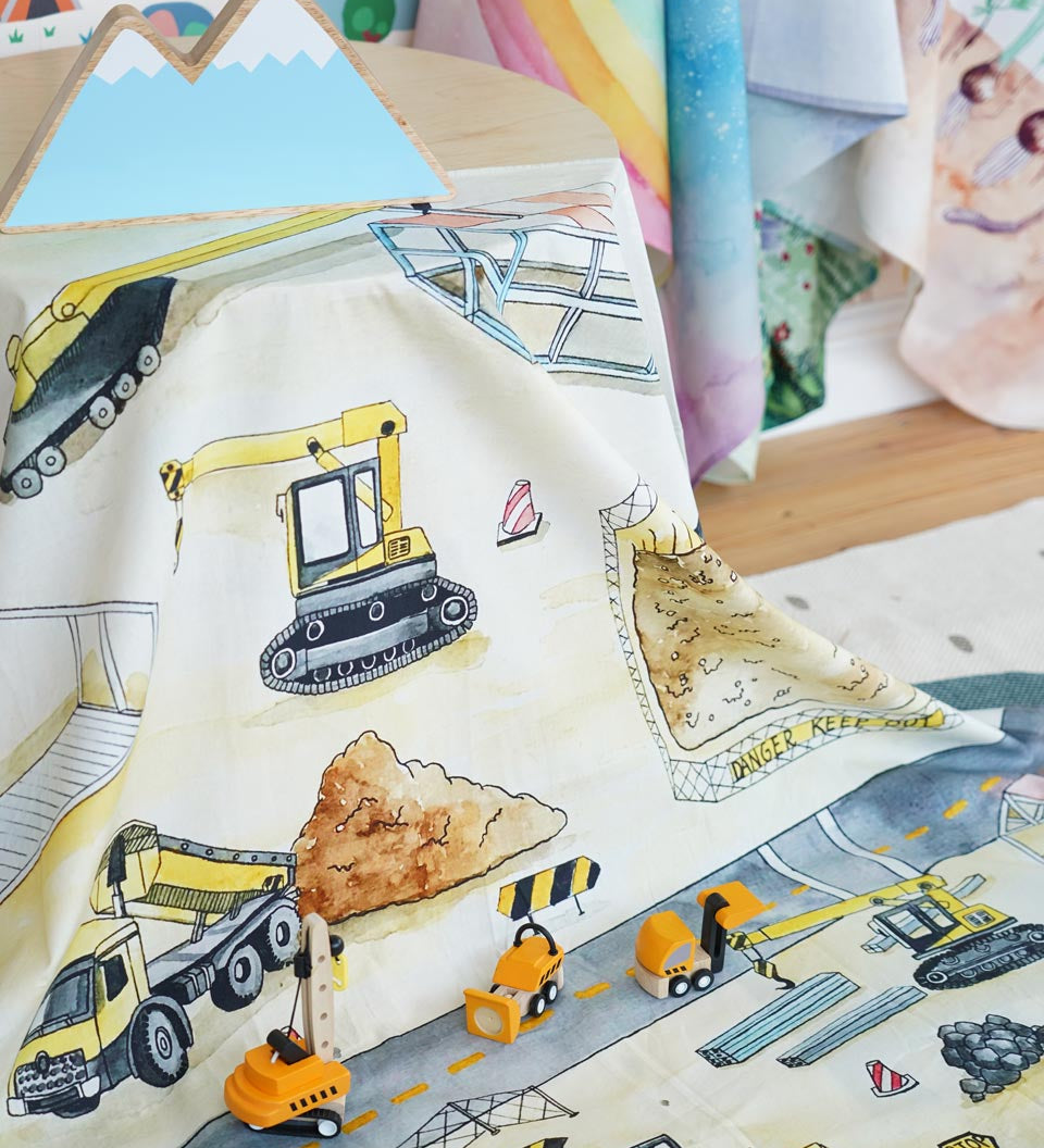 3 small PlanToys construction vehicle toys on the Wondercloths maxi construction site play silk