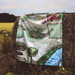 Wondercloths childrens eco-friendly farm print play cloth hanging over a bail of hay in a field