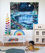 The Wonderie moonlight forest design play cloth hung up on the wall in a playroom. The PlanToys Victorian dolls house, Magic Wood marble tree and the Gwawr rainbow are placed in front. An Olli Ella doll can be seen sitting on the floor at the front on a rug. 
