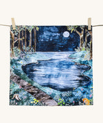 Wonderie Play Cloth featuring the moonlight forest design. Hand illustrated  theme drawings featuring a forest beside a lake underneath a moonlit sky.