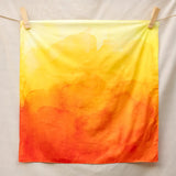 Wonderie organic cotton plain play cloth in amber orange. Ombre effect colour.  