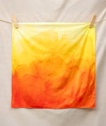 Wonderie organic cotton plain play cloth in amber orange. Ombre effect colour.  