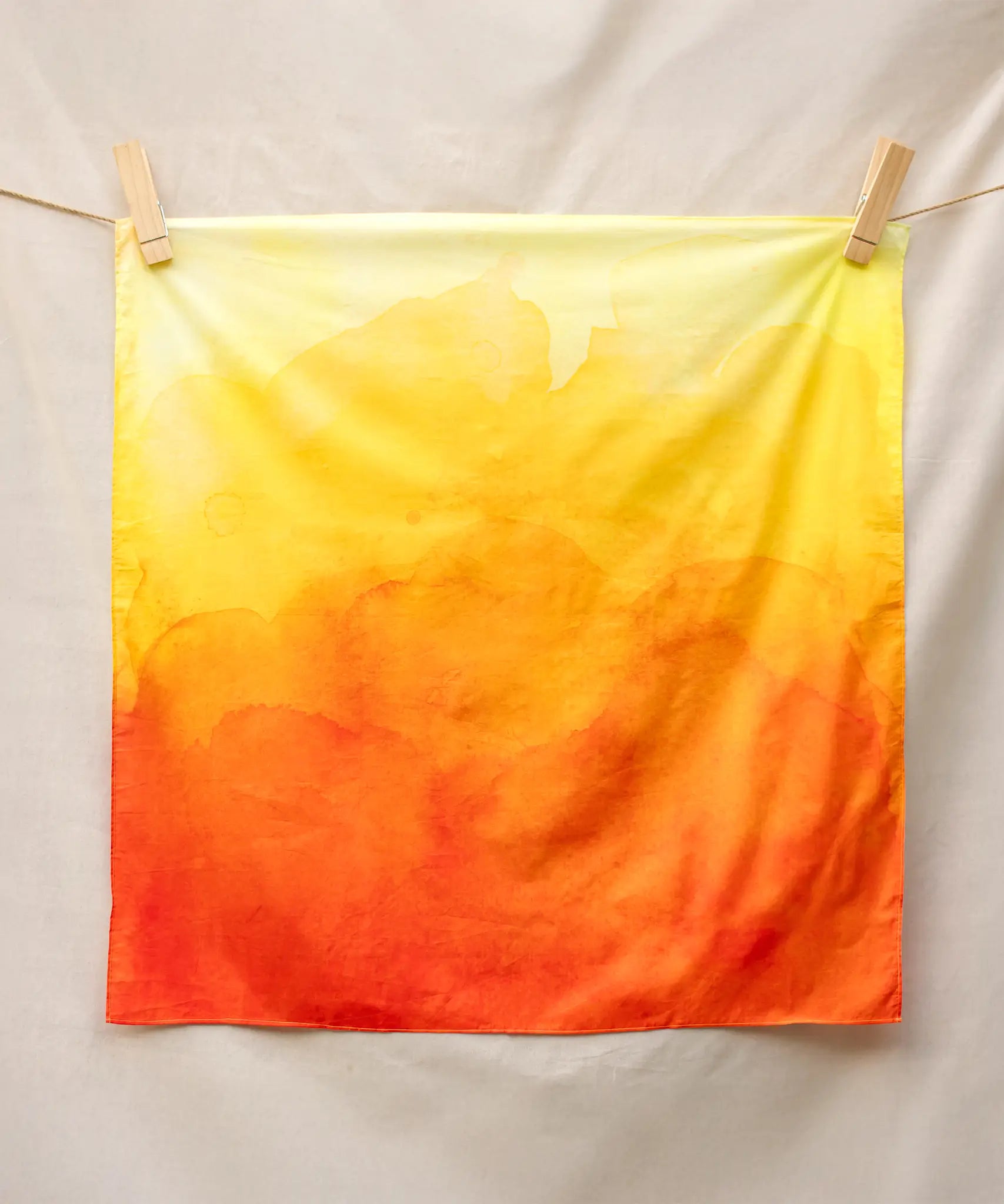 Wonderie organic cotton plain play cloth in amber orange. Ombre effect colour.  