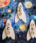 Wooden rockets created using the Grapat petals placed on the Wondercloths Solar System Learning Cloth 