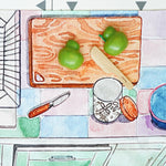 A play vegetable being chopped up on the printed chopping board on the Wonderie Kitchen play cloth
