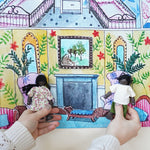 Two dolls sitting on the printed chairs in the Wonderie Sensory Play Cloth - Welcome To The Doll House.