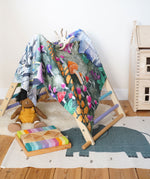 Wonderie Play Cloth with a Enchanted Toadstool Forest design being used as a cover for the TriClimb. 