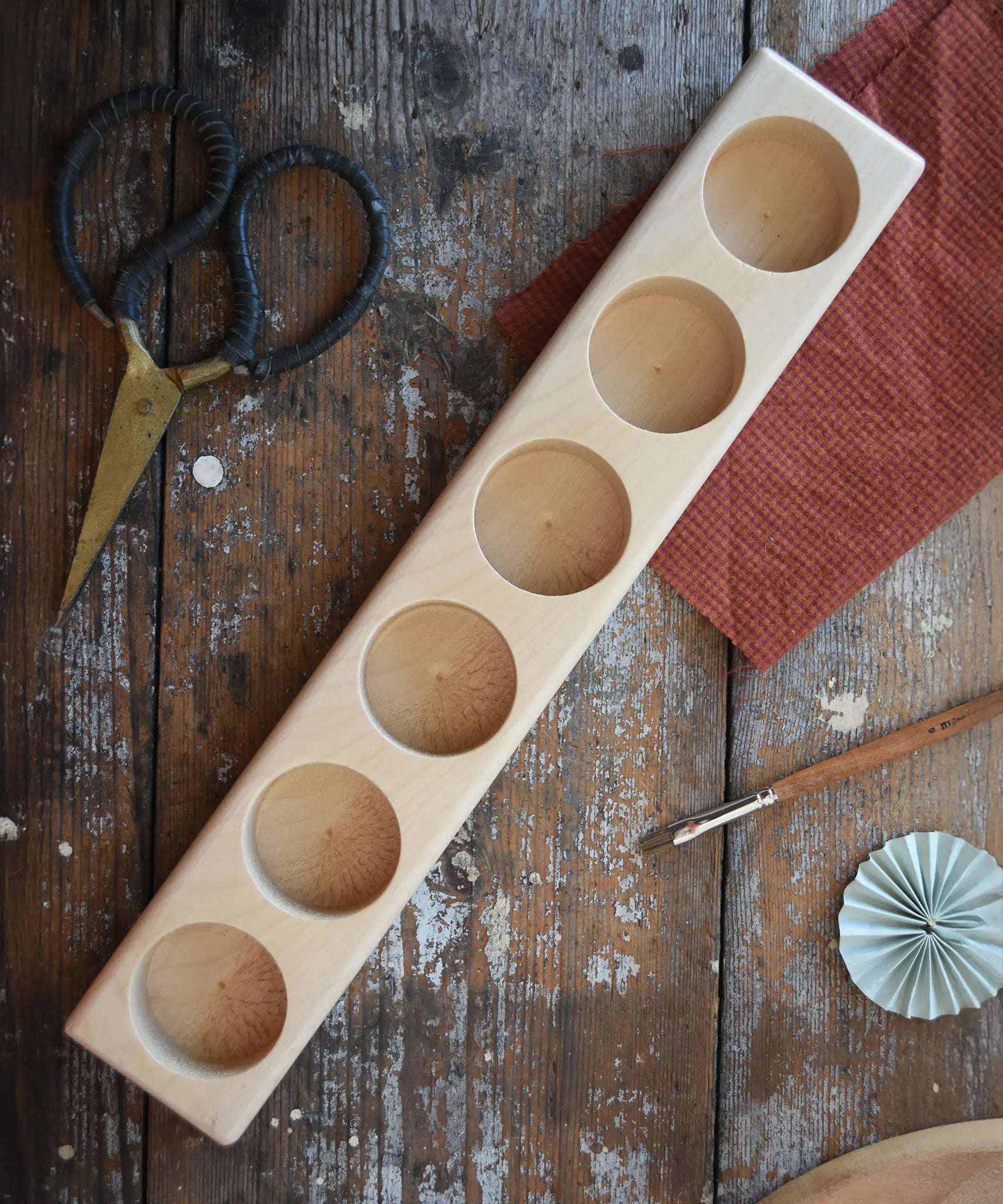 Wooden holder for 6 50ml glass jars, top down view. 